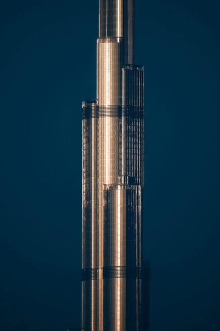 Close-up of the Burj Khalifa illuminated against the night sky in Dubai, showcasing its architectural elegance.