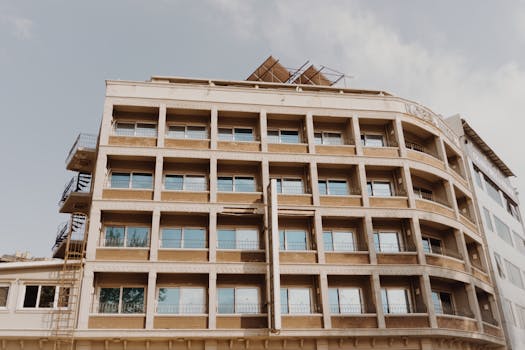 Detailed view of an urban residential building showcasing balconies and fire escape stairs.