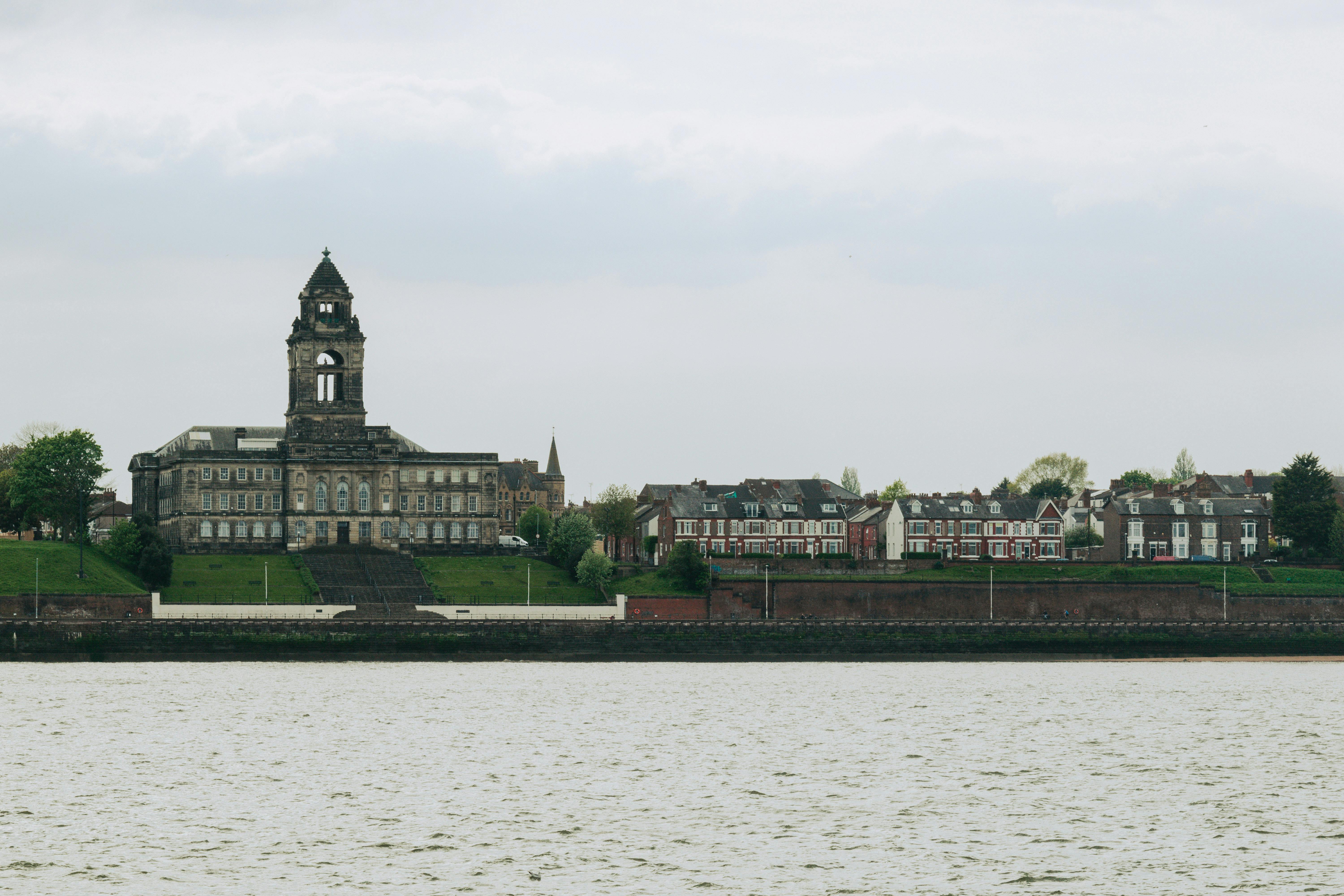 Wallasey Town Hall and surrounding buildings viewed across Liverpool's River Mersey.
