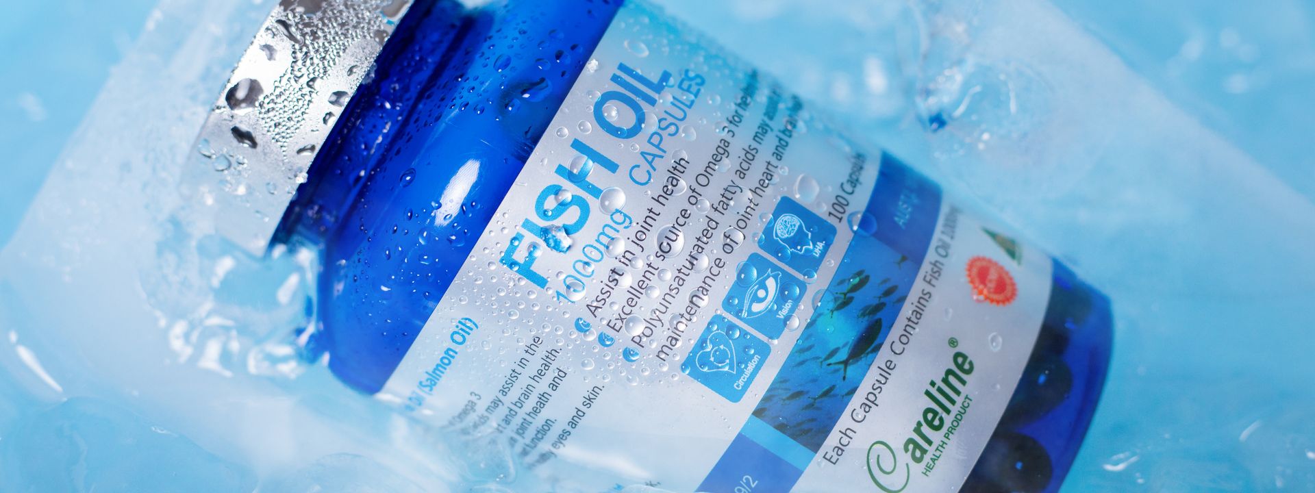 Blue fish oil supplement bottle surrounded by ice in a bright freshness scene