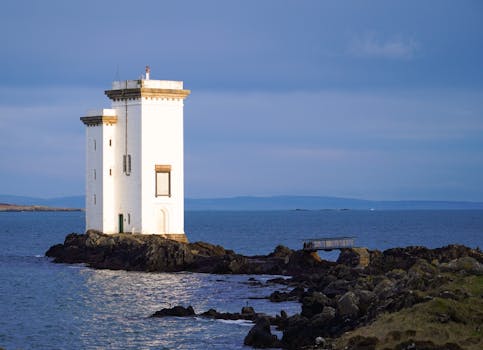 View of the Carraig Fhada Lighthouse on Islay, Scotland by the seashore.