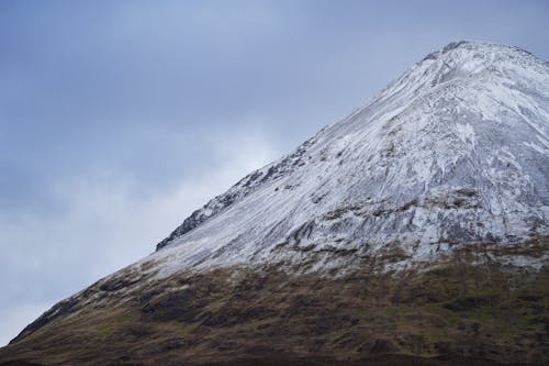 A snow covered mountain with a large white peak
