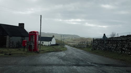 A red telephone box on a country road
