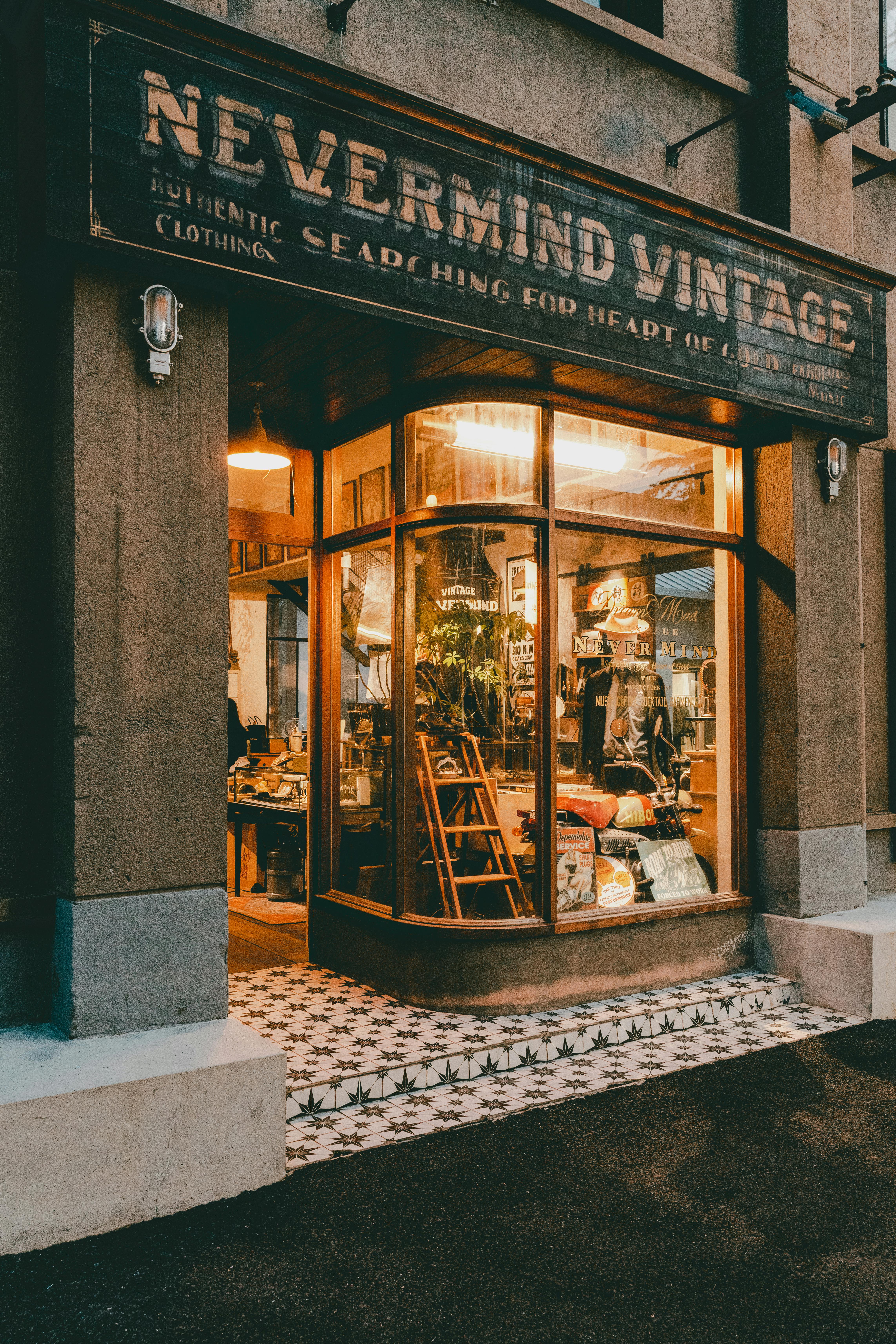 Quaint vintage store entrance with warm, inviting window display.