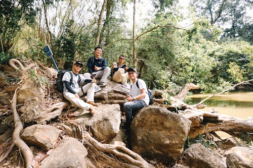 A group of people sitting on rocks in the woods