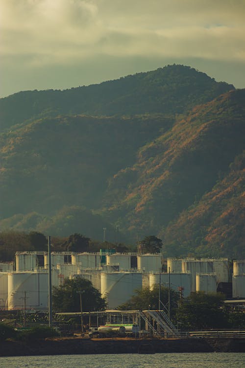 A large white building with a mountain in the background