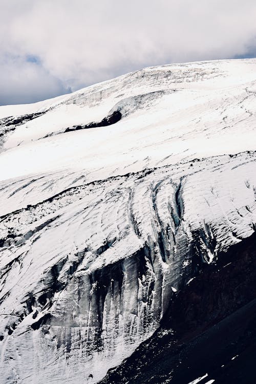 A person standing on top of a snow covered mountain