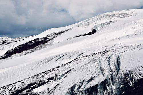 A person is standing on top of a snow covered mountain