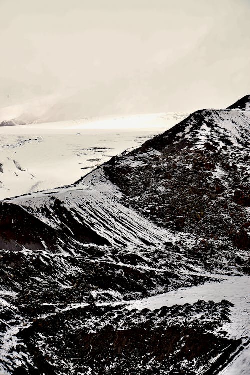 A black and white photo of a snowy mountain