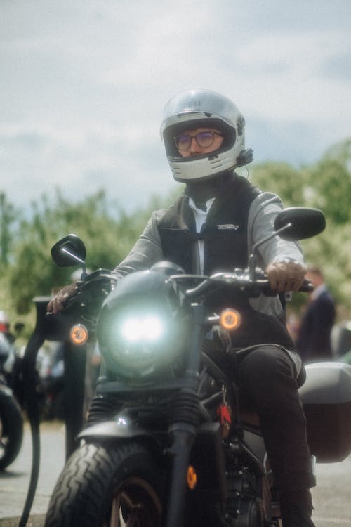 A man on a motorcycle with a helmet on