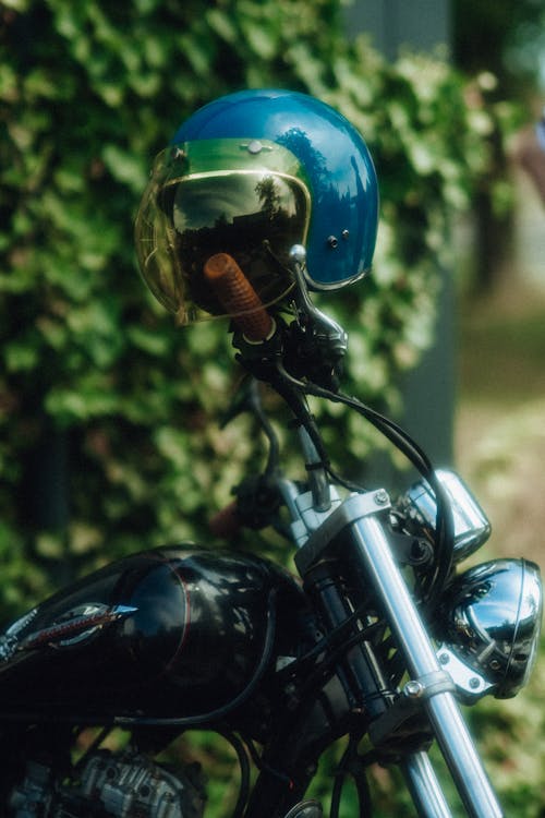 A close up of a motorcycle helmet with a blue visor