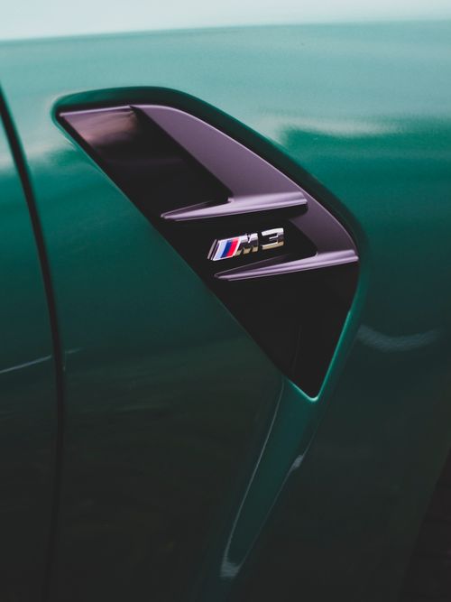 Free Detailed close-up of a green sports car's side vent highlighting the sleek design. Stock Photo