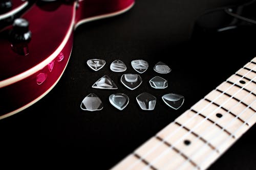 guitar picks and red guitar