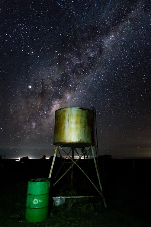 Free Green Metal Tank And Green Drum Under Night Sky Stock Photo