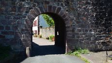 A charming stone archway in the historic town of Saint-Jean-Pied-de-Port, France.
