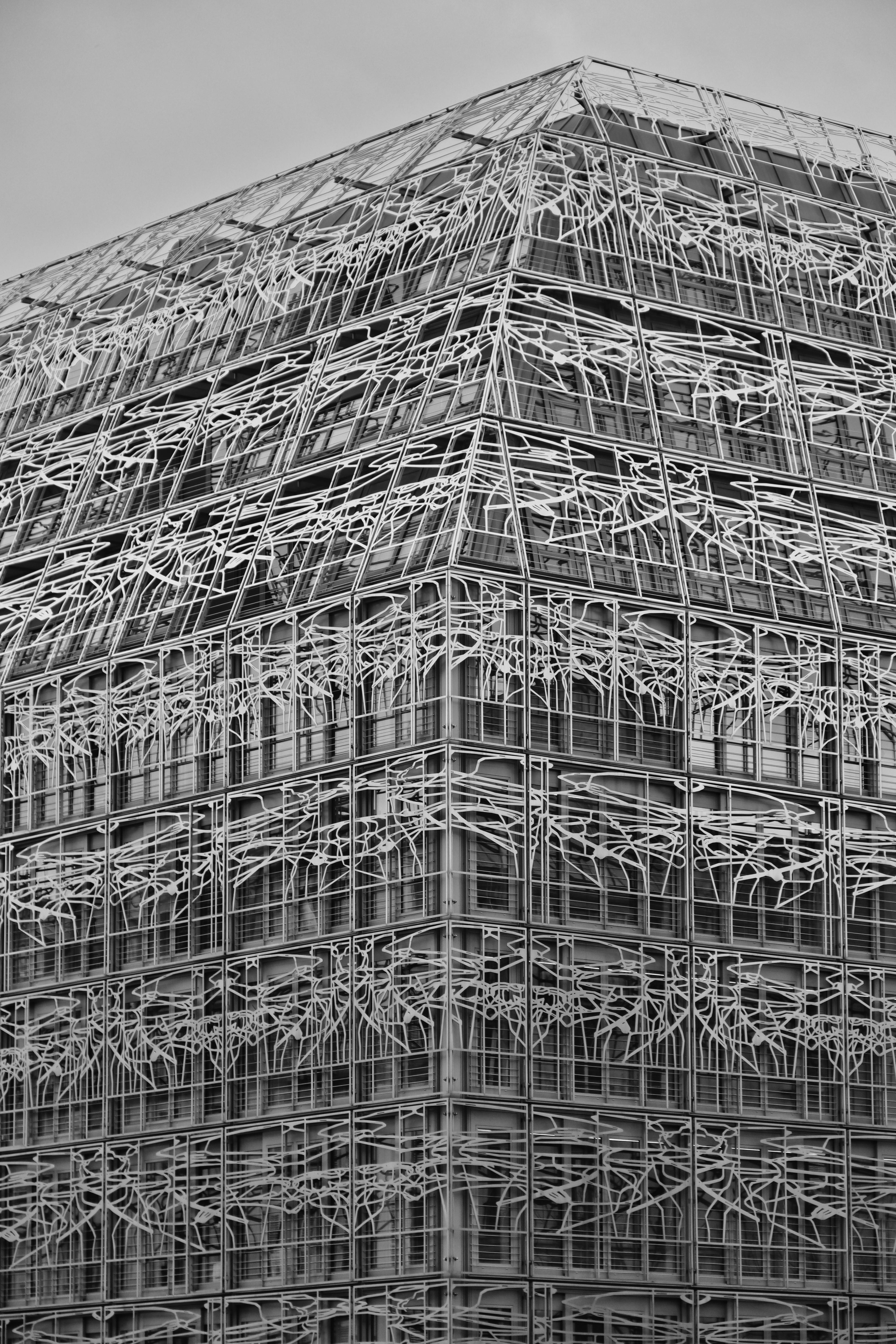 A striking modern building in Paris with geometric patterns and metal structure.