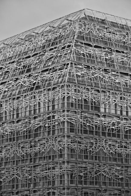 A striking modern building in Paris with geometric patterns and metal structure.
