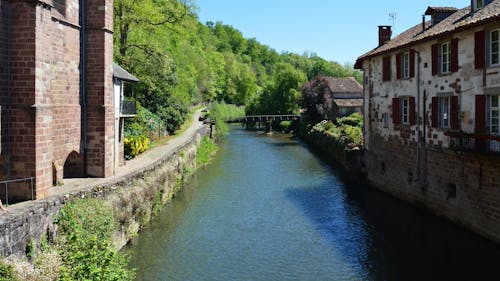 A river runs through a village with old buildings