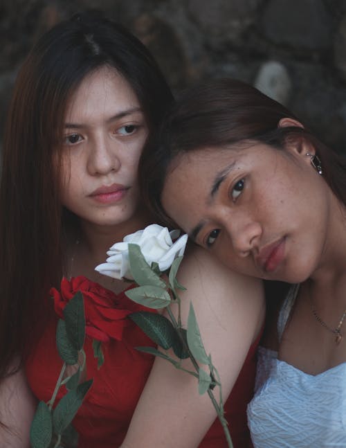 Two Girls With White Flower