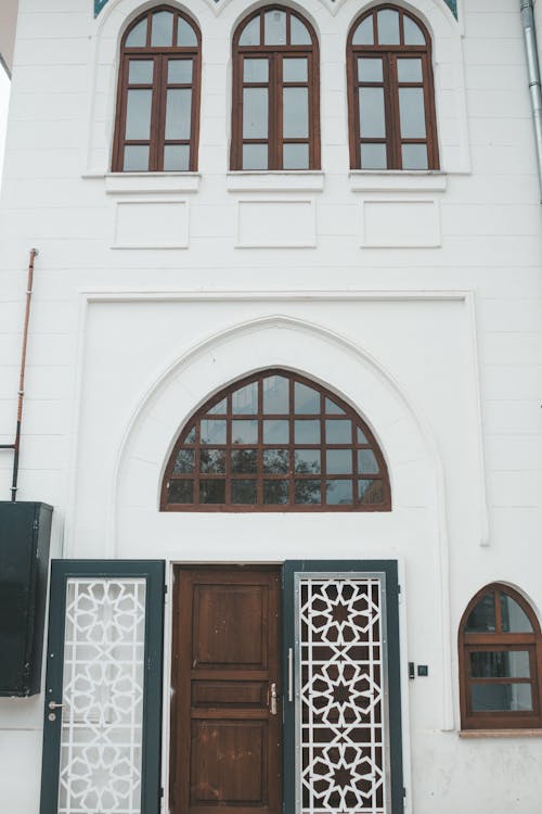 Free Facade of aged traditional oriental white building with wooden doors and windows and ornamental elements Stock Photo