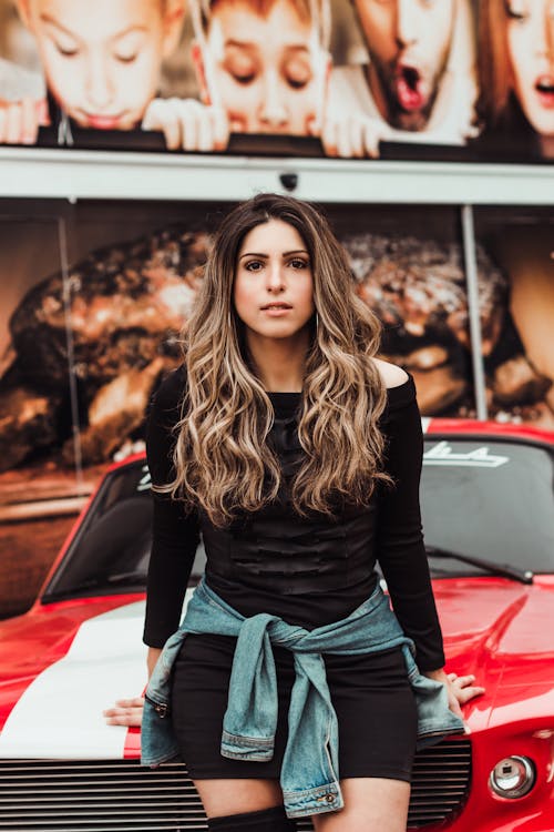 Woman Leaning On Car Hood