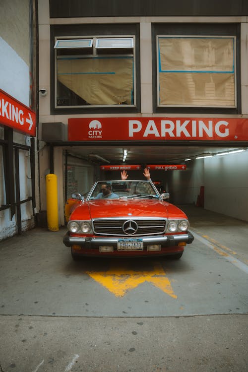 A red car parked in a parking garage