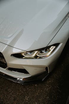 High-angle view of a modern luxury sports car highlighting the sleek headlight design.