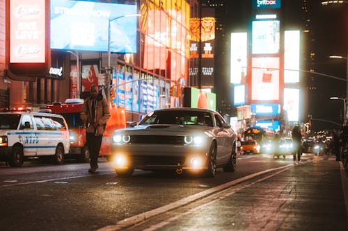 A car driving down a city street at night