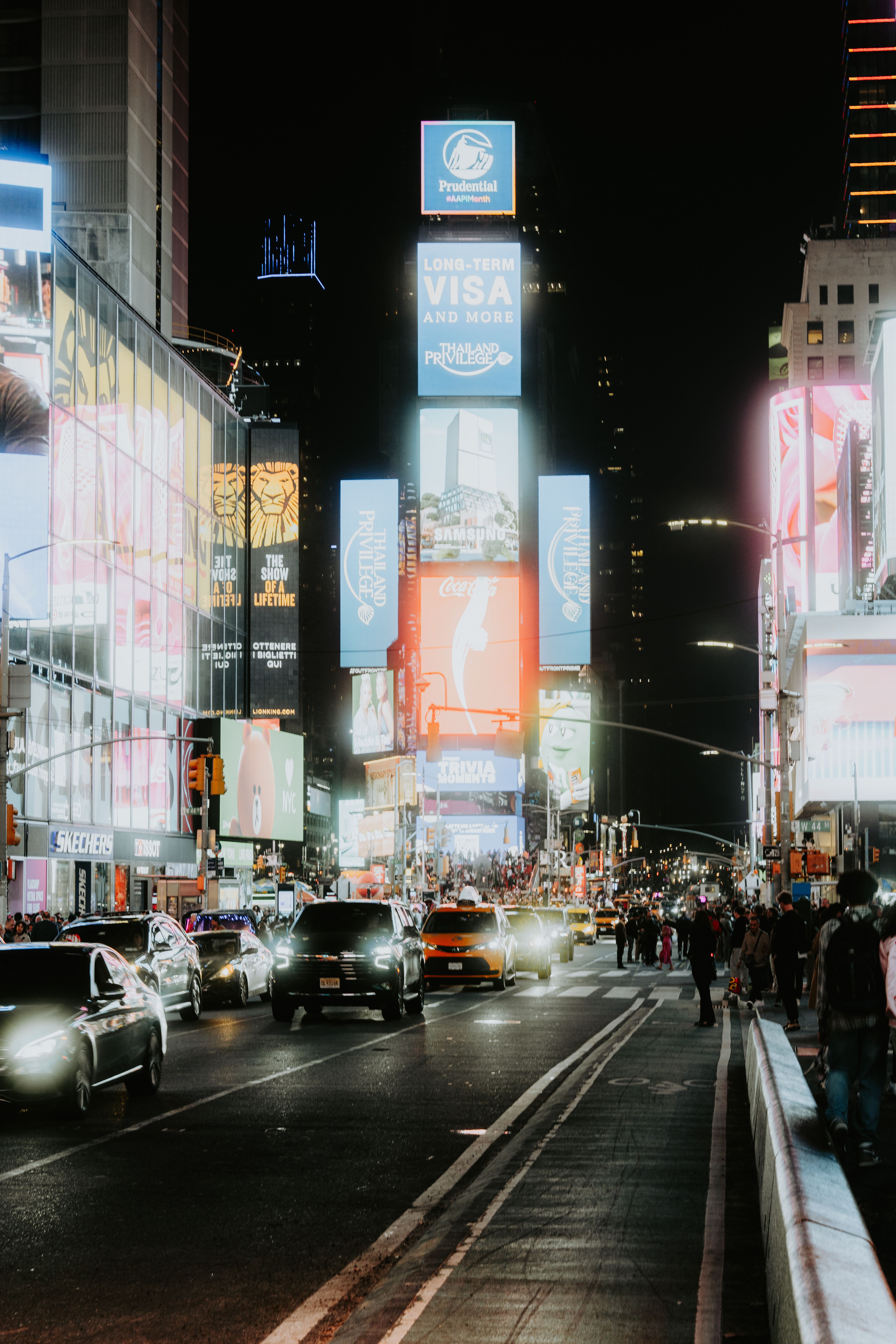 Digital Billboards on Buildings And Traffic on the Street at Night in ...