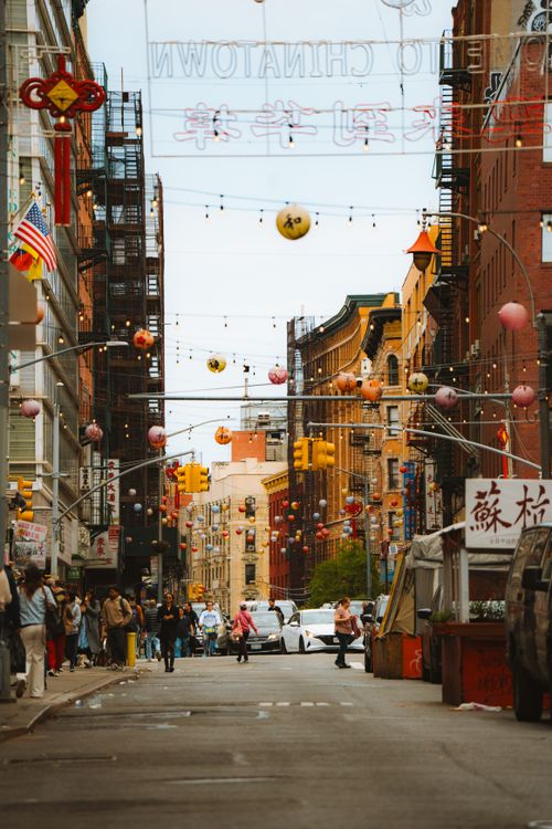 Free Colorful day in NYC's Chinatown with hanging lanterns and bustling street life. Stock Photo