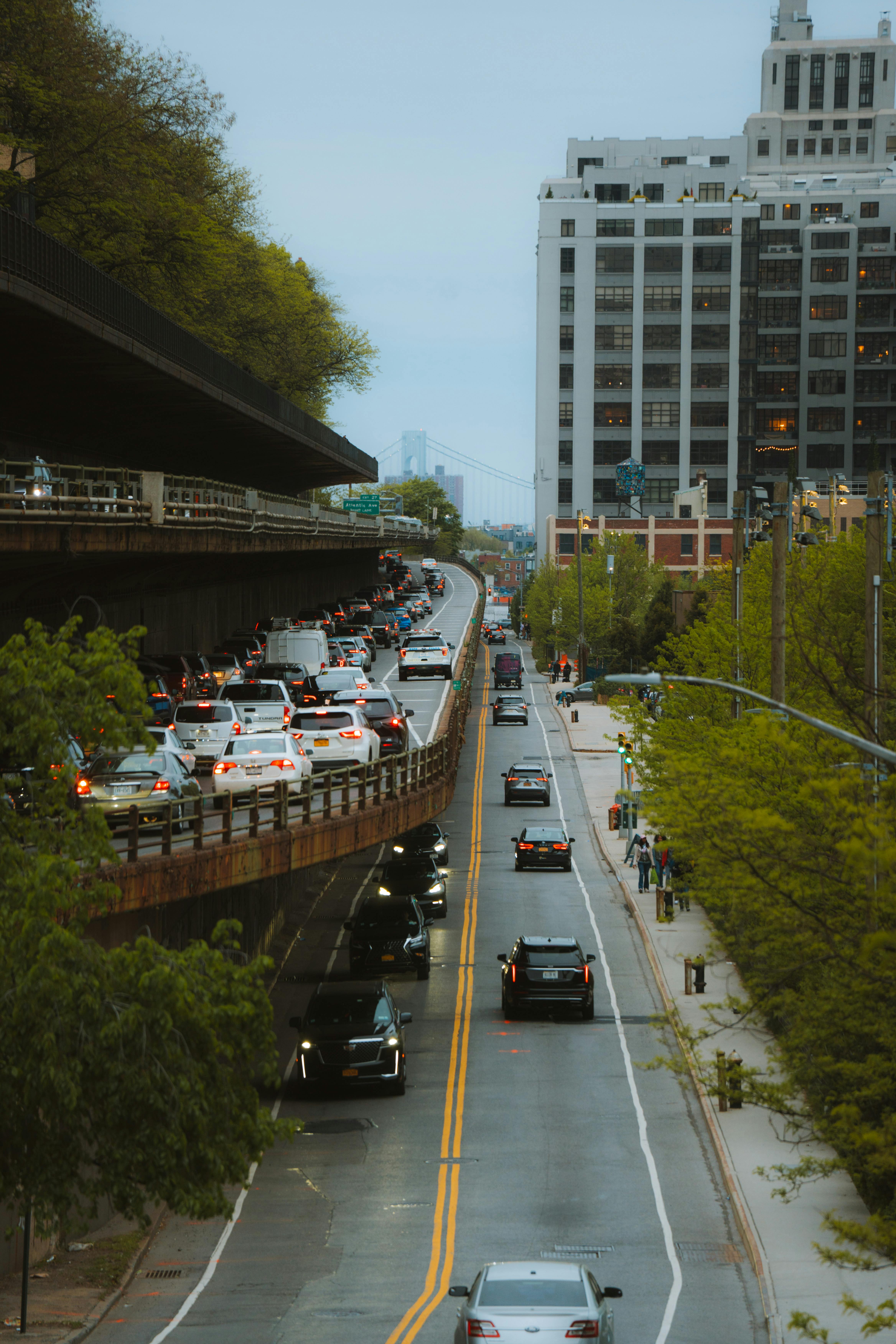 Aerial view of New York City streets with traffic and surrounding buildings on an overcast day.