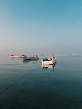 Serene morning view of boats floating on the calm waters near Manama, Bahrain.