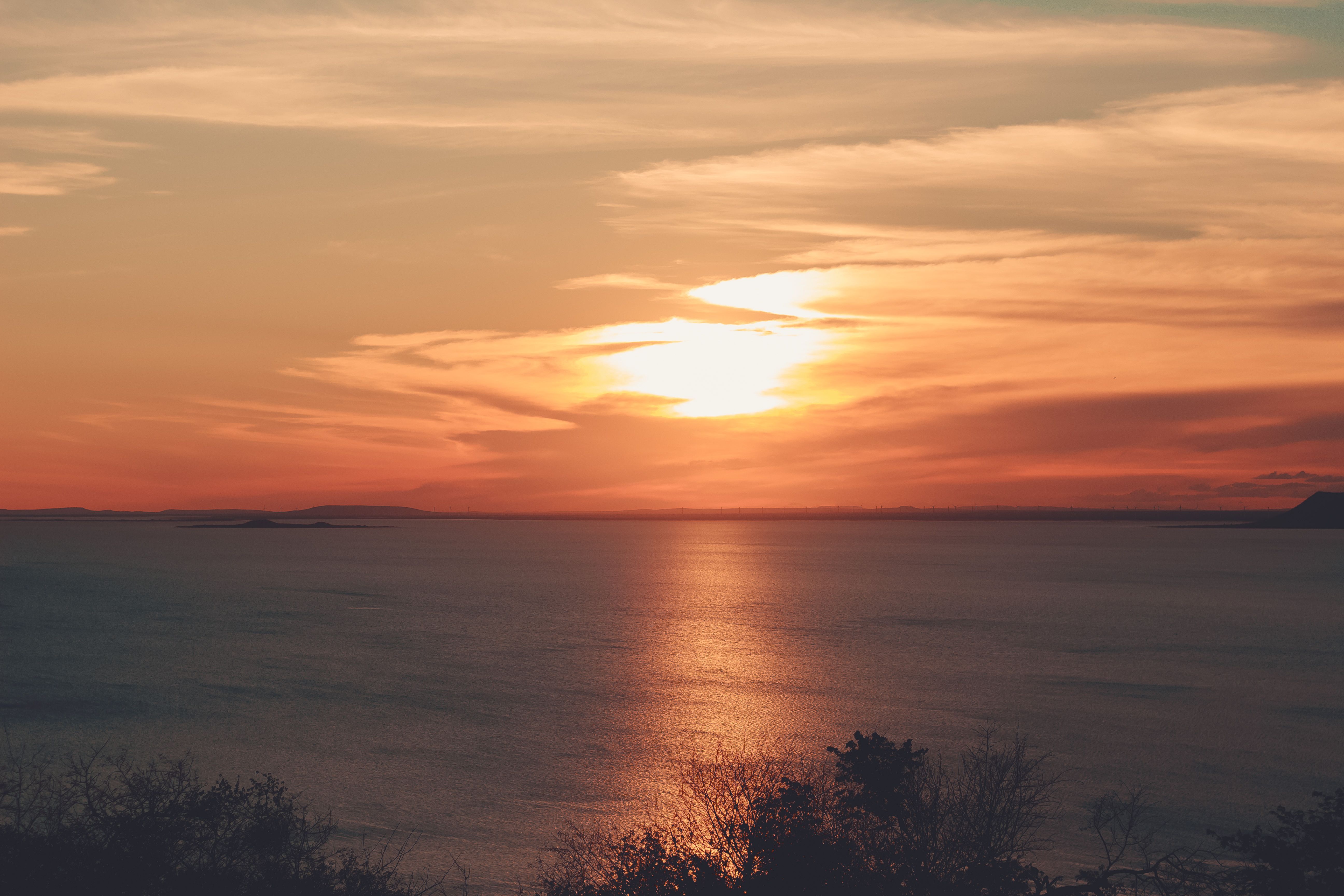 Breathtaking sunset over the coastal waters of Petrolina, Brazil, with vibrant hues and tranquil reflection.