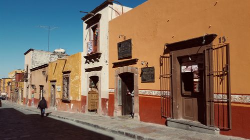 Free Bright colonial buildings line a street in San Miguel de Allende, Mexico. Stock Photo