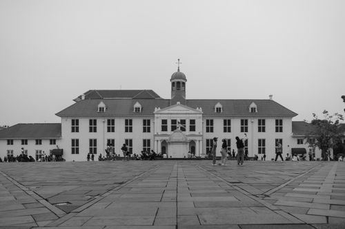 Free Black and white view of Jakarta History Museum with people in the town square. Stock Photo