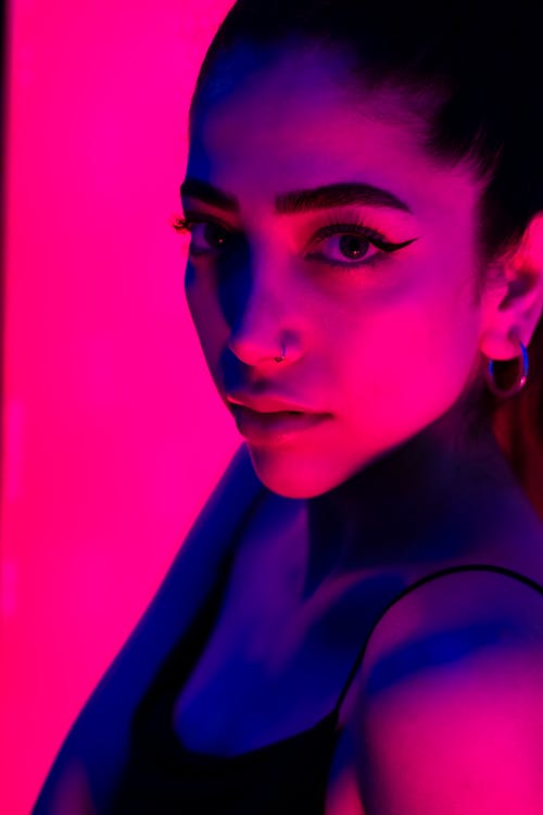 A woman in a pink and purple light