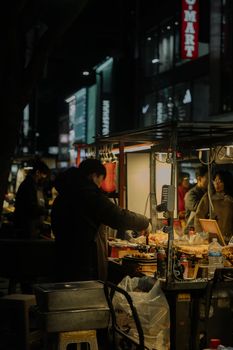Explore the bustling night street food scene with diverse vendors and vibrant atmosphere.