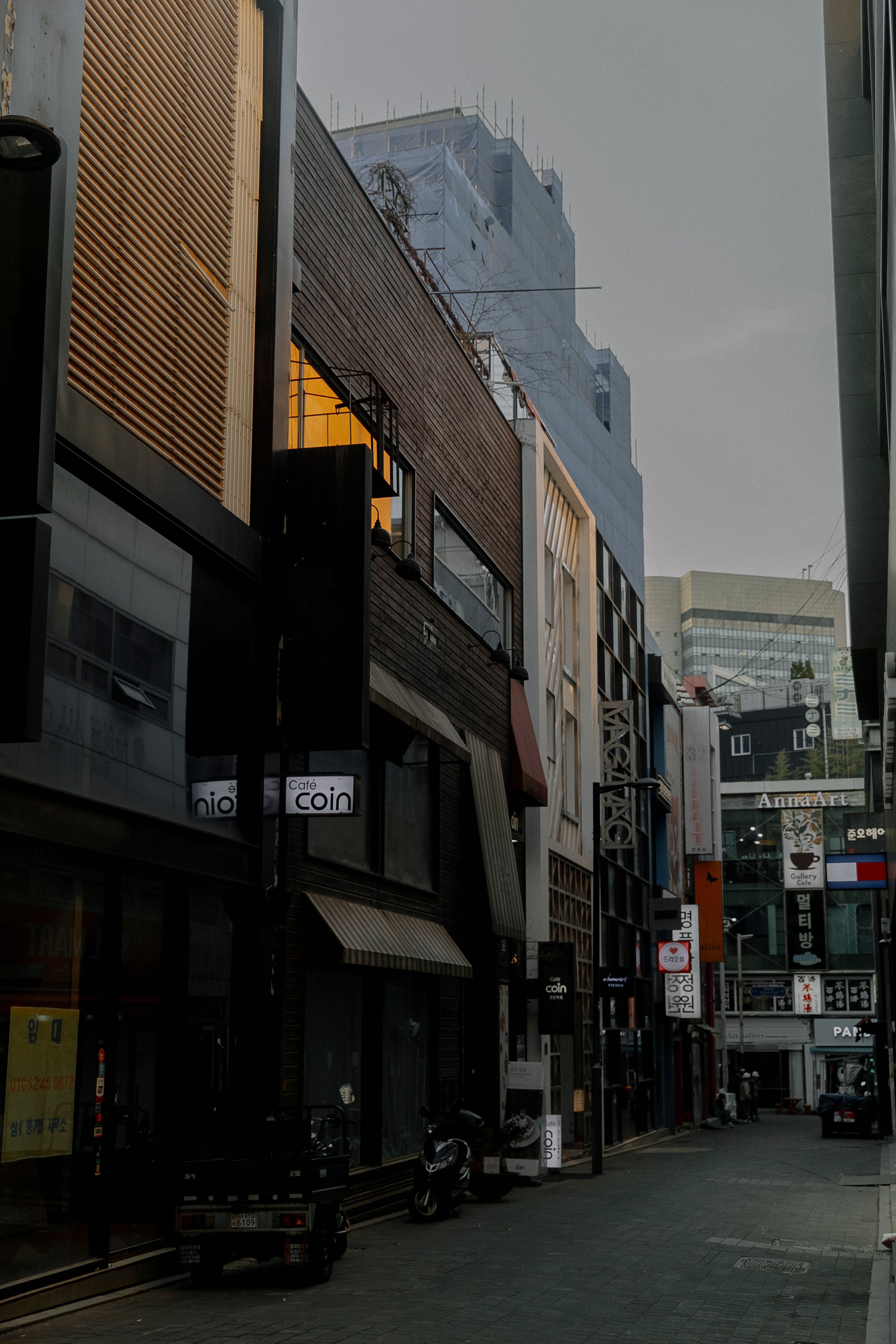 shops in a narrow alley in fog
