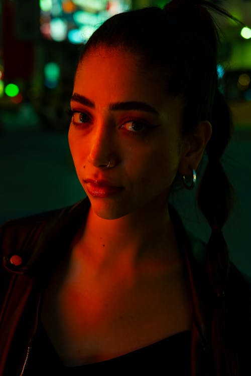 A woman with a black jacket and red lights