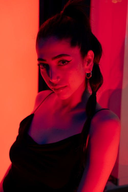 A woman in black dress with red light