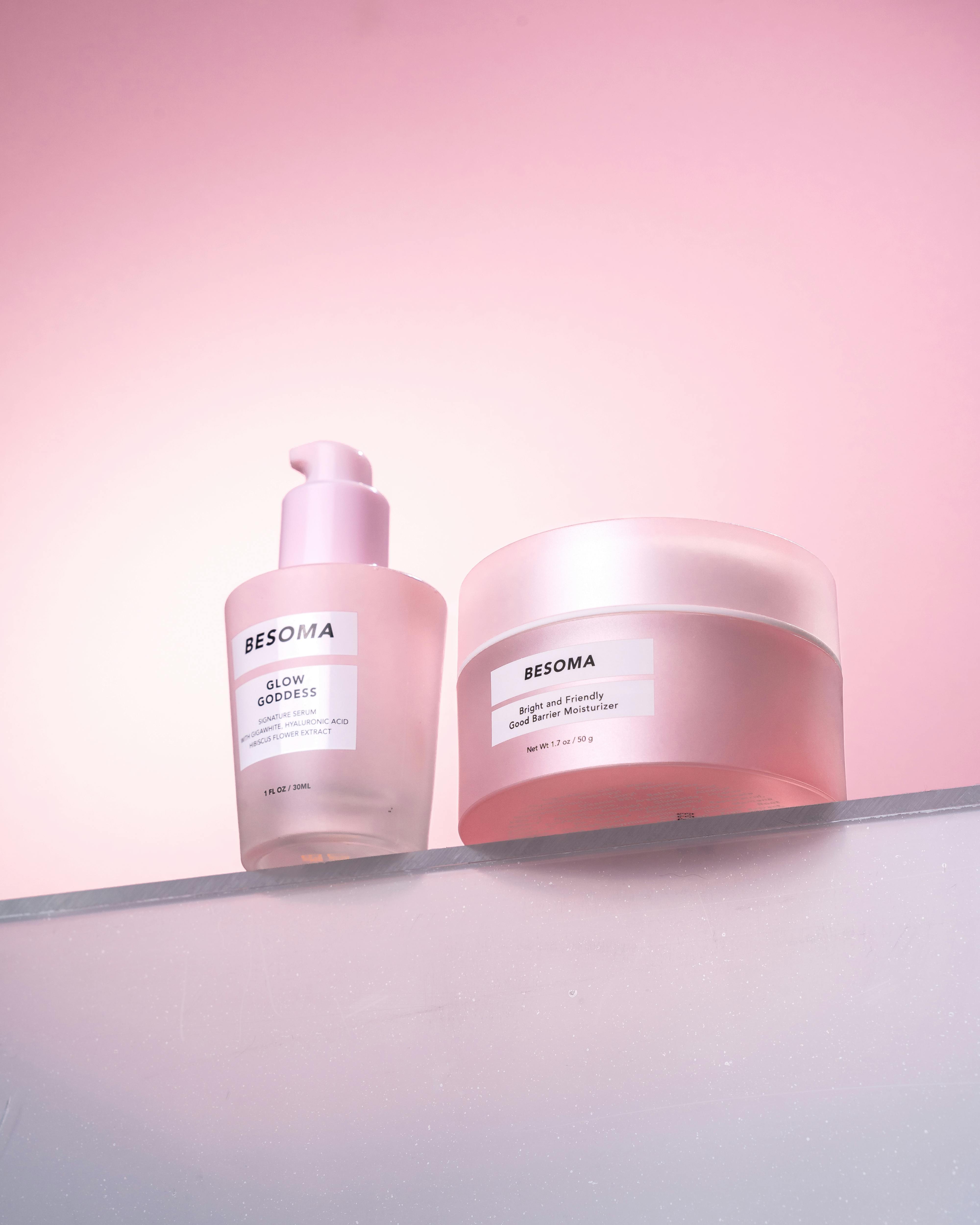 Minimalist skincare product photo with a pink glow for organic beauty.