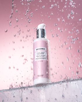 Studio shot of Besoma jelly cleanser bottle with water, emphasizing freshness and hygiene.