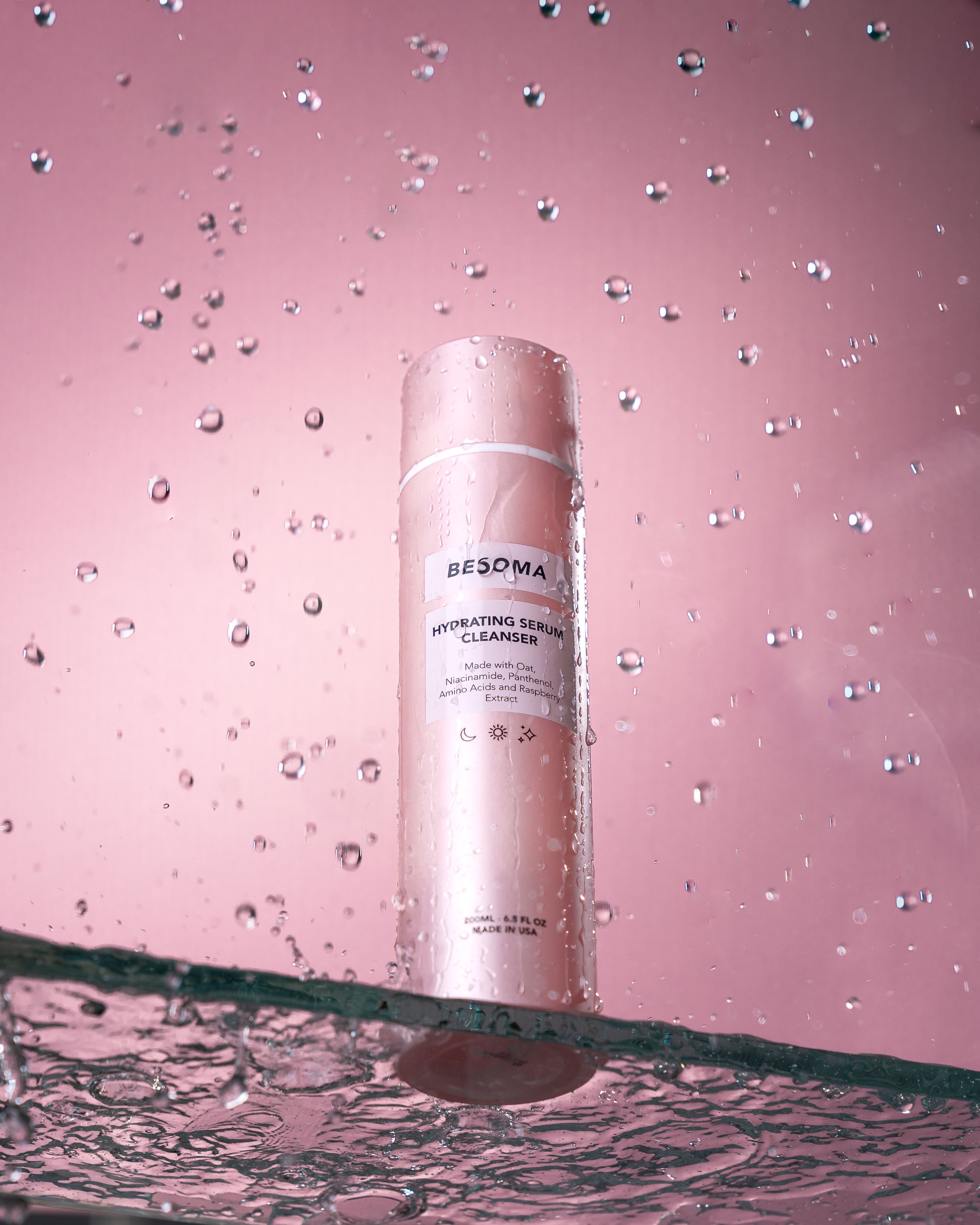 Liquid skincare cleanser bottle with water droplets without people