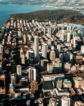 Explore the stunning aerial view of Vancouver's urban skyline against the coastal backdrop.