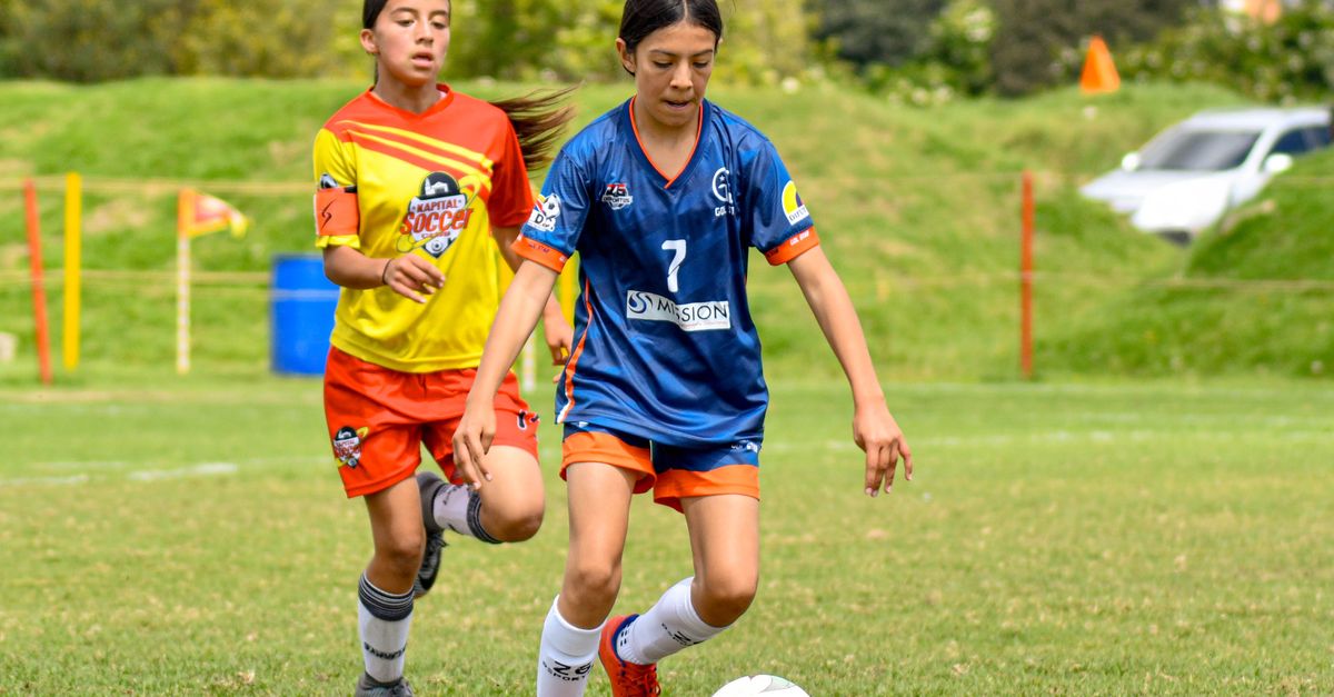 young girls playing soccer training academy happy