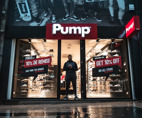 Free Man Standing at the Doorway of Pump Shop Stock Photo