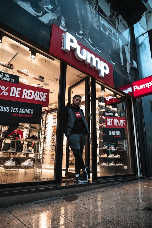 Man Standing on Pump Store's Doorway