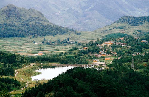 A view of a valley with mountains and water