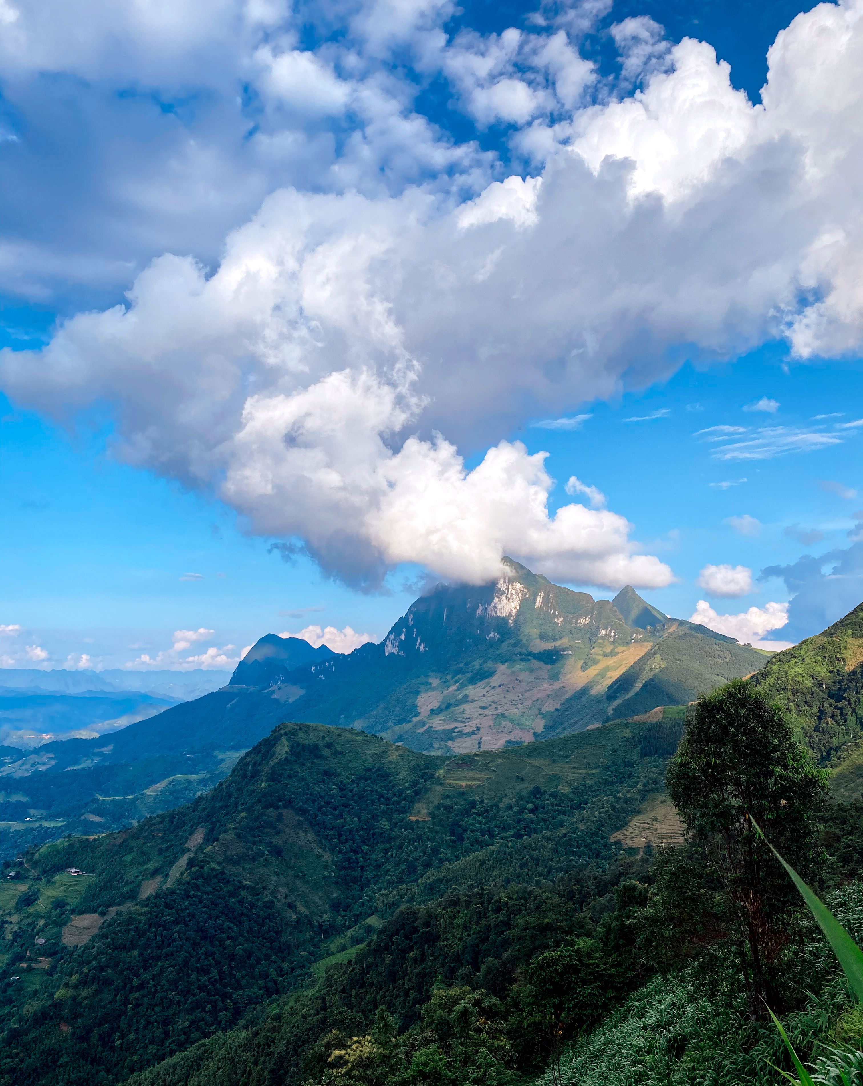 Stunning view of a mountainous landscape under a dramatic cloud formation, perfect for nature enthusiasts.
