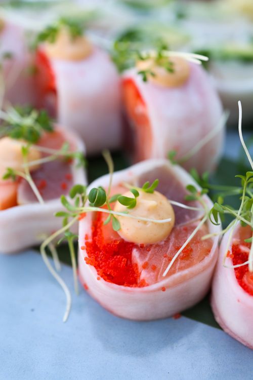 Free Close-up of Japanese sashimi rolls with salmon and red caviar, garnished with microgreens. Stock Photo